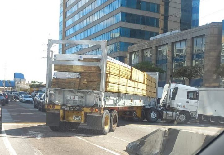 A truck tries to turn onto the westbound lane of Wrightson Road, Port-of-Spain, yesterday, near Dock Road, where traffic was at a standstill as vehicles waited in line to board the Cabo Star vessel to go to Tobago. SOCIAL MEDIA