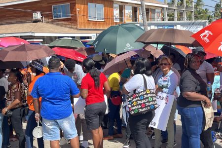 Teachers on strike protesting along the Port Mourant, Corentyne Public Road yesterday a stone’s throw away from where President Irfaan Ali was commissioning the first phase of the Guyana Technical Training College Inc. 