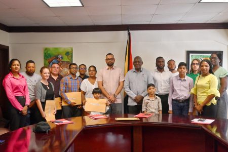 This Ministry of Home Affairs photo shows the 17 new citizens and officials of the ministry. (Ministry of Home Affairs photo)