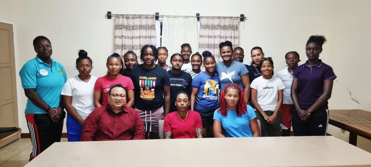 GCB President Bissoondyal Singh (left, front row sitting), poses with the Guyana National Women’s team. Guyana’s captain Shamaine Campbell (2nd from left) and Cherry-Ann Fraser (right) are pictured sitting next to him.