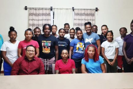 GCB President Bissoondyal Singh (left, front row sitting), poses with the Guyana National Women’s team. Guyana’s captain Shamaine Campbell (2nd from left) and Cherry-Ann Fraser (right) are pictured sitting next to him.