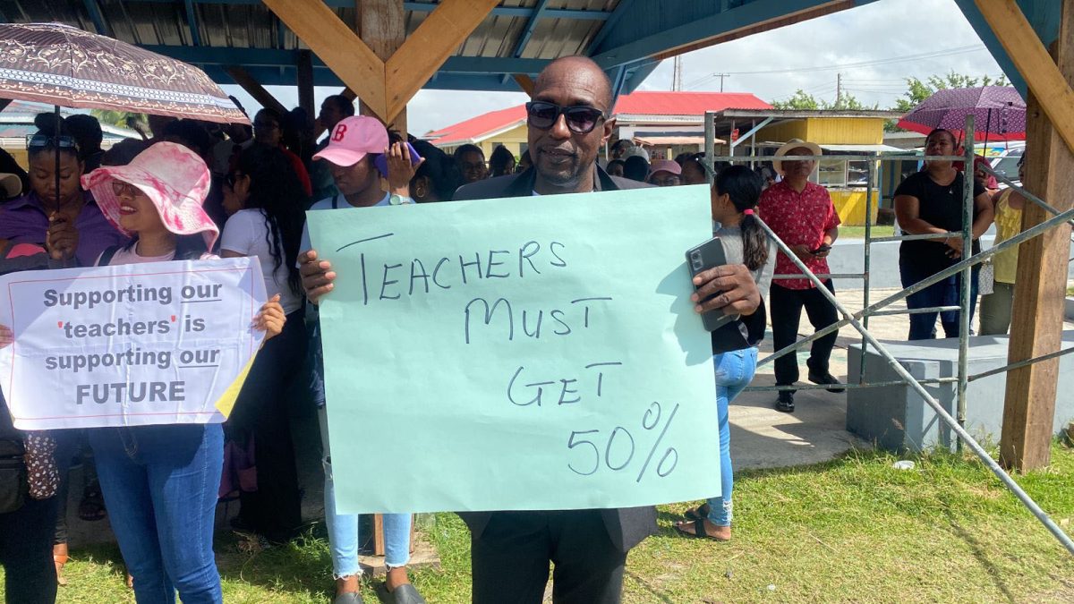 A teacher with a placard
