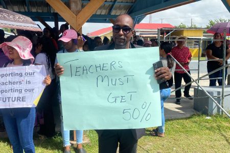 A teacher with a placard
