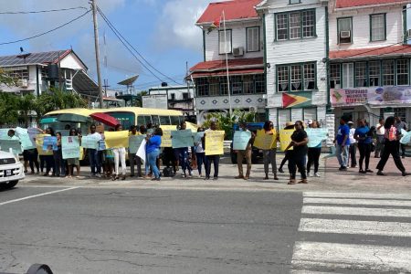 Teachers with placards outside of the ministry.