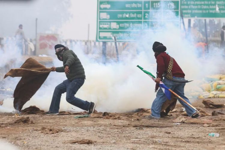 A farmer reacts as tear gas is fired at farmers marching toward the Indian capital, February 21, 2024. Reutershttps://kathmandupost.com/world/2024/02/21/police-fire-tear-gas-on-indian-farmers-marching-to-capital-government-offers-talks