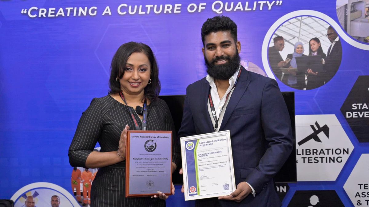 Regional General Manager of Analytical Technologies Inc., Amrita Ballie and Director of Technical and Operations Group of Analytical Technologies Inc.,  Nathan Maharaj pose with the GNBS Certificate and Plaque.  (GNBS photo)
