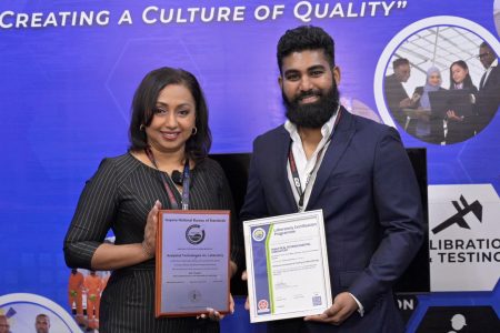 Regional General Manager of Analytical Technologies Inc., Amrita Ballie and Director of Technical and Operations Group of Analytical Technologies Inc.,  Nathan Maharaj pose with the GNBS Certificate and Plaque.  (GNBS photo)
