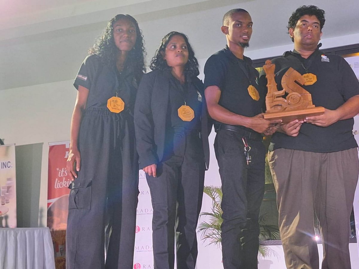 Guyana’s 1 team from left Jessica Callender, Shazida Rahim, and FM Anthony Drayton and CM Taffin Khan pose with their spoils after finishing second in the
CARICOM Classic Chess Championship.

