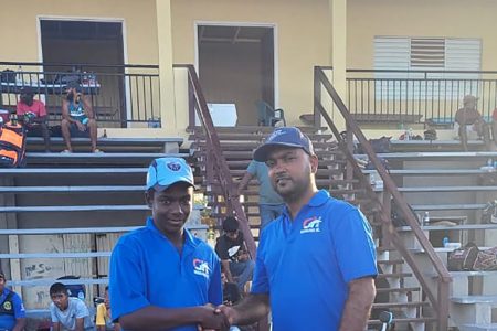 WDCA U15 Batsman Pameshwar Ram (left) receiving the cricket equipment from Gamal Hamid
of GH Renovations