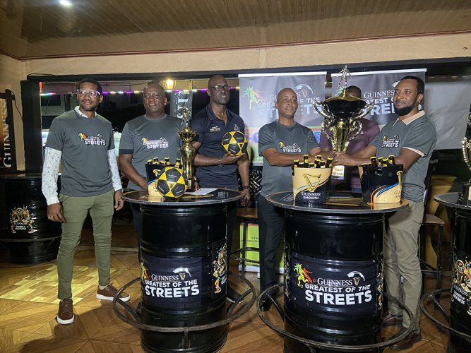 Tournament coordinator Rawle Welch (4th from left) receiving the championship trophy from Guinness Brand Manager Jeoff Clement in the presence of other event officials, including Guinness Brand Executive Lee Baptiste (2nd from left)