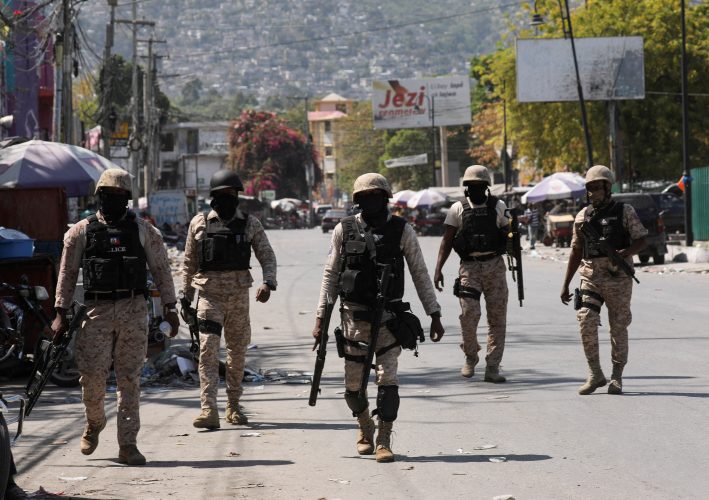 FILE PHOTO: Police patrol a street after authorities extended the state of emergency amid gang violence that has threatened to bring down the government, forcing thousands to flee their homes, in Port-au-Prince, Haiti March 8, 2024. REUTERS/Ralph Tedy Erol/File Photo