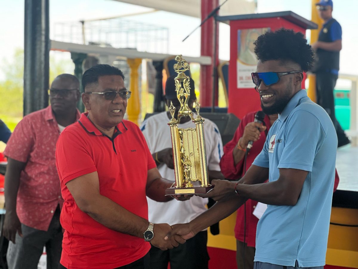 Briton John receives his winner’s trophy and purse from the Minister of Agriculture and PPP/C Executive Secretary Zulfikar Mustapha
(Photo: Michelangelo Jacobus)
