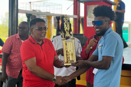 Briton John receives his winner’s trophy and purse from the Minister of Agriculture and PPP/C Executive Secretary Zulfikar Mustapha
(Photo: Michelangelo Jacobus)
