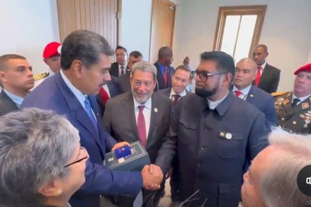 The two leaders share a handshake after President Nicolas Maduro (left) received his gift from President Irfaan Ali. St Vincent and the Grenadines Prime Minister Ralph Gonsalves (centre) beams at the exchange.
