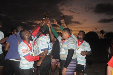 The victorious Panthers celebrate with their spoils after beating the Police Falcons 19-12 in the final of the John Lewis Memorial 7s Rugby Tournament.