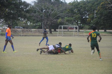 A GPF player (left) tackles a GDF opponent during their fixture
