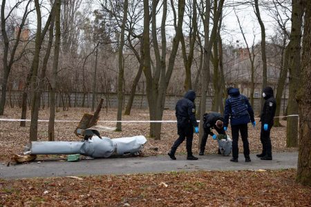 Police officers inspect a part of a Russian Kh-55 cruise missile in a park in Kyiv, March 24, 2024. (Reuters photo)