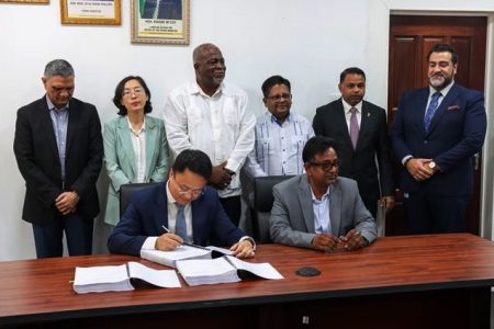 Prime Minister Mark Phillips, Senior Minister within the Office of the President with responsibility for Finance and Public Service, Dr Ashni Singh and Minister within the Ministry of Public Works, Deodat Indar with representatives from GUYSOL, SUMEC and IDB. (DPI photo)
