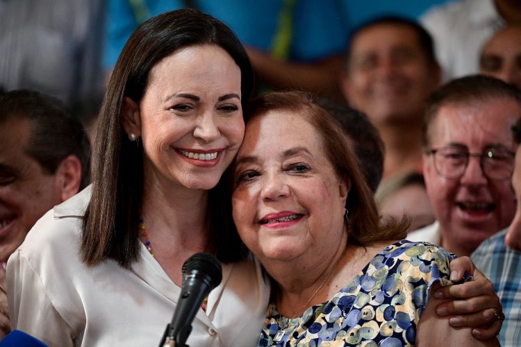 Venezuelan opposition leader Maria Corina Machado (left) embraces Corina Yoris Villasana whom she nominated to replace her as a presidential candidate, during a press conference, in Caracas, Venezuela, March 22, 2024.