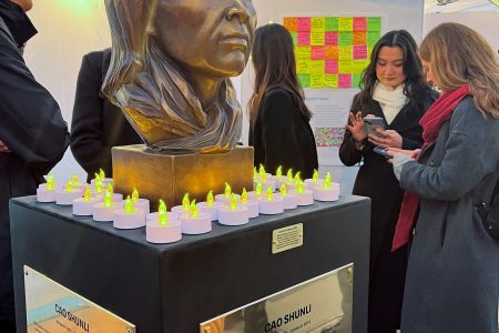 A statue of late Chinese human rights activist Cao Shunli is seen surrounded by candles at a reception in Geneva, Switzerland, March 14, 2024. REUTERS/Emma Farge