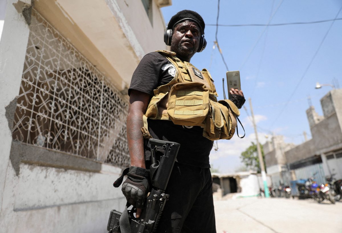 FILE PHOTO: Former police officer Jimmy “Barbecue” Cherizier, and leader of an alliance of armed groups, speaks to a news outlet on a mobile phone during a news conference, in Port-au-Prince, Haiti, March 11, 2024. REUTERS/Ralph Tedy Erol/File Photo
