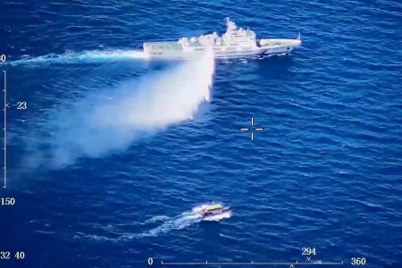 A Chinese Coast Guard ship launches what the Coast Guard says is a warning water cannon spray in the direction of a Philippine vessel at an unknown location at sea in this screen grab taken from a video released on August 8, 2023. China Coast Guard/Handout via REUTERS