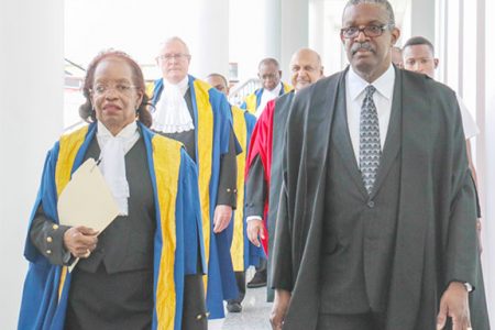 Justice Desiree Bernard (left) making her way into a special sitting of the Caribbean Court of Justice (CCJ) held in 2014 to mark her retirement. Justice Bernard was appointed to the CCJ in 2005 and was the first woman to join the court. In this Arian Browne photo, Justice Bernard walks besides Chief Justice of Belize Kenneth Benjamin.