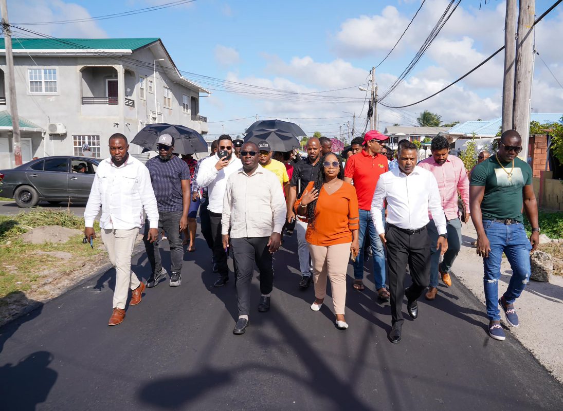 Following Vice President Bharrat Jagdeo’s visit to East Ruimveldt and promises of infrastructural development for the community, Ministers Deodat Indar and Kwame McCoy yesterday visited the neighbourhood to inspect the completed and ongoing works, a release from the Ministry of Public Works said.
Accompanied by scores of residents and technical officials, the Ministers engaged the contractors from the community who were awarded projects to uplift the living standard of East Ruimveldt. (Ministry of Public Works photo)