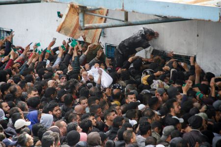 Palestinians gather to receive aid outside an UNRWA warehouse as Gaza residents face crisis levels of hunger, amid the ongoing conflict between Israel and Hamas, in Gaza City March 18, 2024. REUTERS/Mahmoud Issa