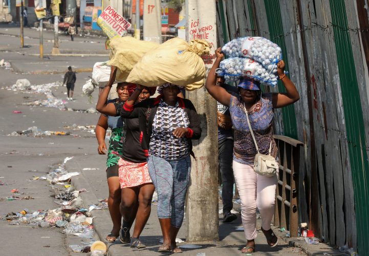 People flee their homes holding their belongings to escape gang violence, as Haiti continues in a state of emergency, in Port-au-Prince, Haiti March 6, 2024. REUTERS/Ralph Tedy Erol