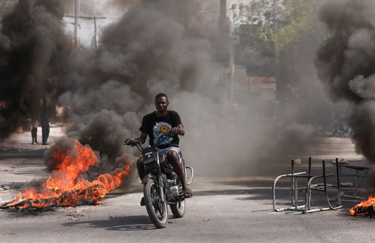 A man drives past a burning barricade during a protest against Prime Minister Ariel Henry’s government and insecurity, in Port-au-Prince, Haiti March 1. REUTERS/Ralph Tedy Erol