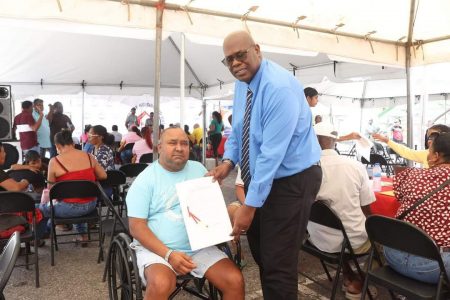 A land title being handed over by CH&PA CEO,  Sherwyn Greaves (CH&PA photo)