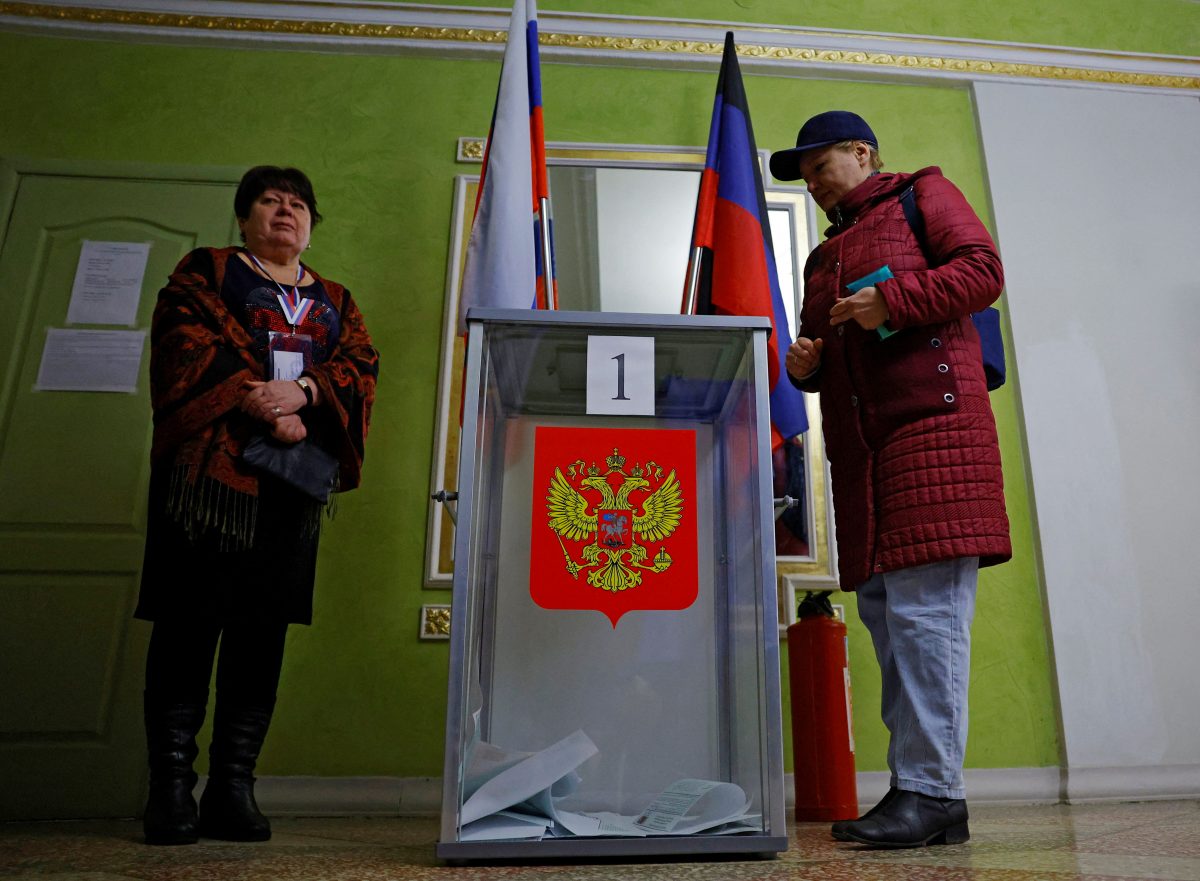 A woman casts her ballot at a polling station during the Russia’s presidential election, in the course of Russia-Ukraine conflict in Donetsk, Russian-controlled Ukraine, March 16, 2024. REUTERS/Alexander Ermochenko