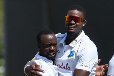 Jason Holder (right) and Kemar Roach
