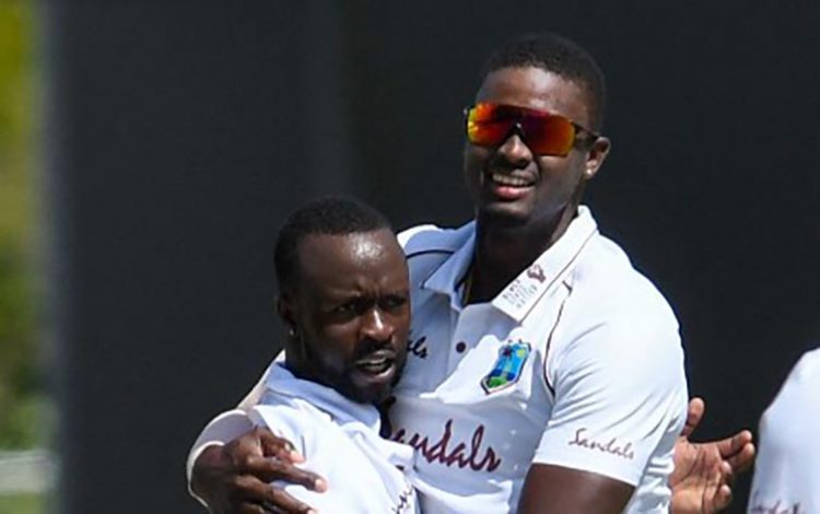 Jason Holder (right) and Kemar Roach
