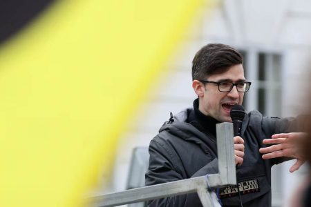 Leader of Austria’s Identitarian Movement Martin Sellner speaks during a protest against a police raid at his house, outside the Justice Ministry in Vienna, Austria, April 13, 2019.