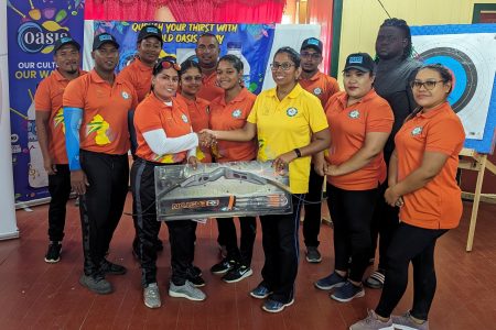 President of Archery Guyana Vidushi Persaud-McKinnon (5th from right) presents to President Wazeeda Bacchus of Essequibo Archers and other Executive Committee members
