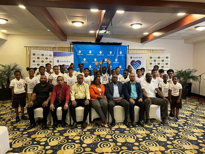 (L-R) GCB Cricket Operations Manager Anthony D’Andrade, GCB Secretary Ronald Williams, Republic Bank’s Harry Dass Ghaness, a Republic Bank
representative, Director of Sport Steve Ninvalle, Allied Arts Unit Head Nicholas Fraser, and National Five for Fun Coordinator Reon King all pose for
a photo with some of the participating students from various primary schools.