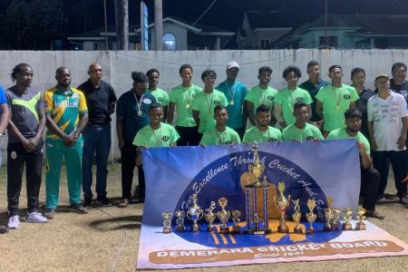 The winning GCA U-19 team poses with their spoils of victory