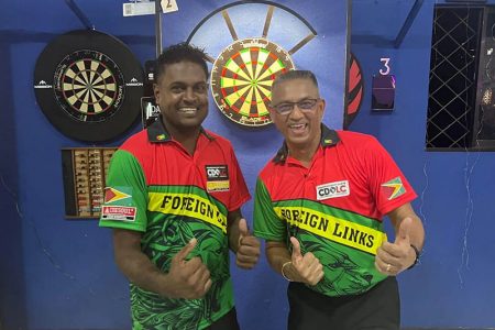 Jubilation! The team of Sudesh Fitzgerald (left) and Norman Madhoo celebrates after sealing their place in the World Cup of Darts