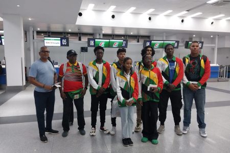 The Guyanese contingent of (L-R Back Row) Ramdeo Kumar, Coach Linden Johnson, Malachi Moore, Colin Wong, Krystian Sahadeo, Umar Percival, Jonathan Van Lange, (L-R Front Row) Samara Sukhai, and Akira Watson pose for a photo prior to their departure from the CJIA.