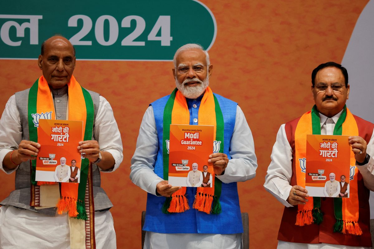 Indian Defence Minister Rajnath Singh, Prime Minister Narendra Modi and President of the Bharatiya Janata Party J. P. Nadda display copies of the ruling Bharatiya Janata Party’s (BJP) election manifesto for the general election, in New Delhi, India, April 14, 2024. REUTERS/Adnan Abidi
