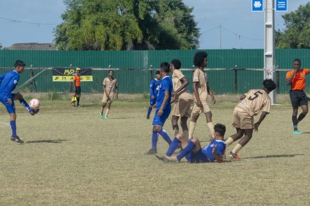 Action in the Milo Secondary Schools Football Championship between Charlestown (brown) and Santa Rosa
