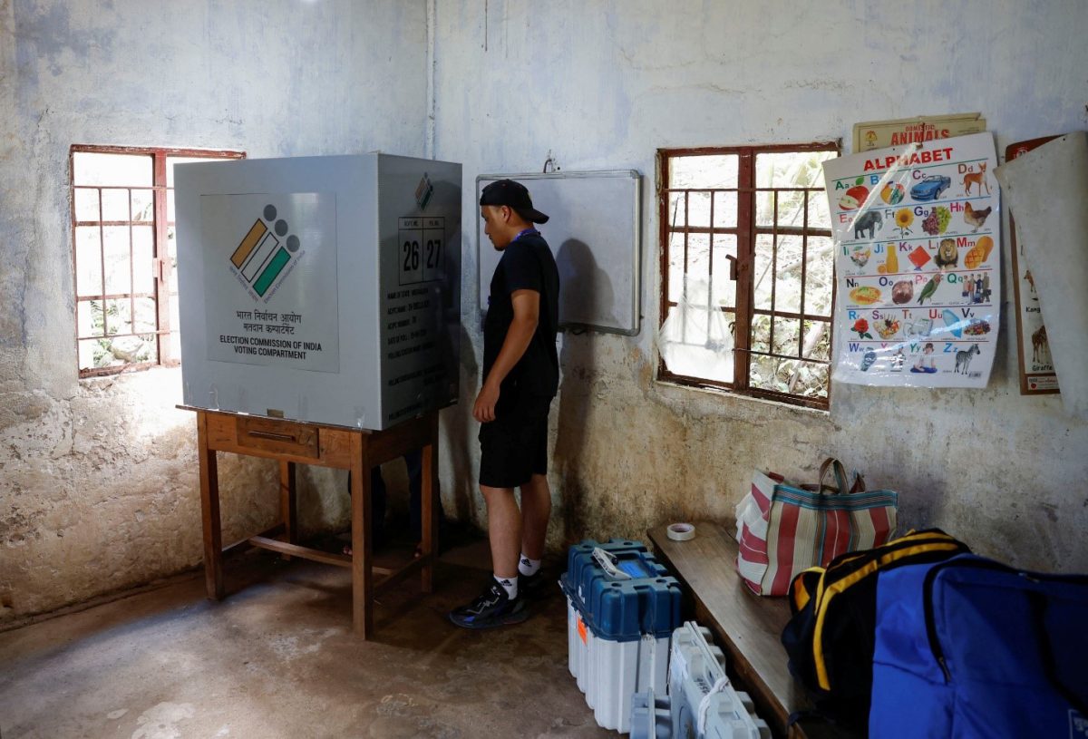 Polling officer Stevenson M. Khonglah, sets up the polling booth in Nongriat village, the location of a remote polling station, on the eve of the first phase of the election, in Shillong in the northeastern state of Meghalaya, India, April 18, 2024. REUTERS/Adnan Abidi 