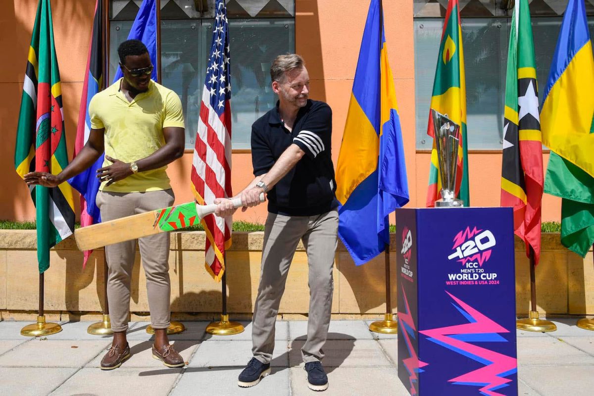  US Ambassador to Barbados & the Eastern Caribbean, Roger Nyhus gets batting tips from Carlos Brathwaite during the ICC Men’s T20 World Cup 2024 trophy tour at the US Embassy in Barbados. The bat is the one Brathwaite used in the 2016 final when West Indies won. (Windies Cricket Facebook page) 