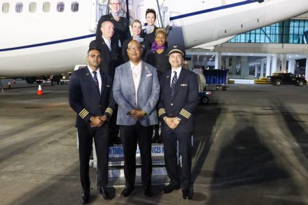 Public Works Minister Juan Edghill (centre) with the flight crew (CJIA photo)