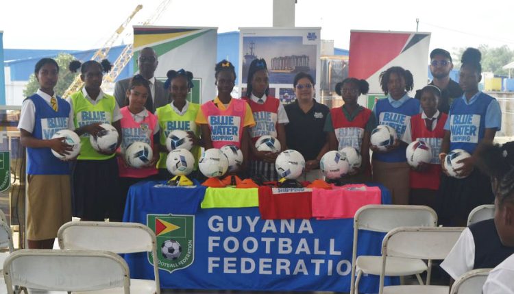 GFF President Wayne Forde (4th from left) and Senior Vice President of Sales at Blue Water, Richard De Nobrega (2nd from right), posing with students from the
various competing teams at the launch of the tournament
