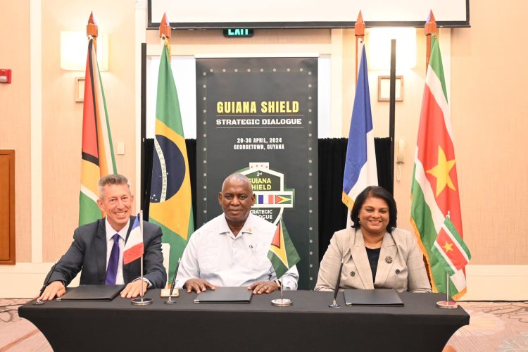 From left at the signing of the pact are French Ambassador to Guyana, Nicolas De Lacoste; Home Affairs Minister Robeson Benn and Suriname Defence Minister, Krishnakoemarie Mathoera (Ministry of Home Affairs photo)