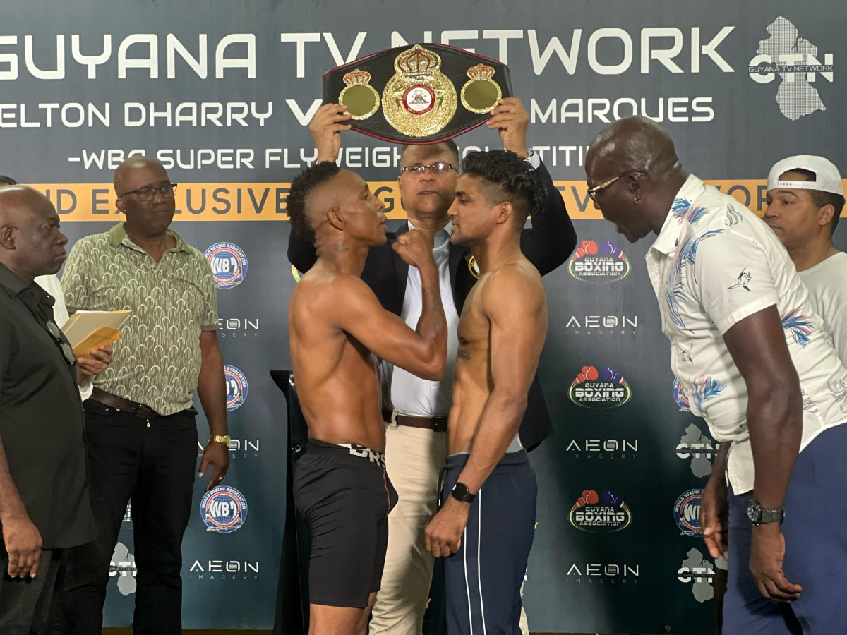 The tension ran high as Dexter Marques (left) and Elton Dharry faced off last evening ahead of their WBA Super Flyweight Gold Belt (in the background) title bout slated for tonight