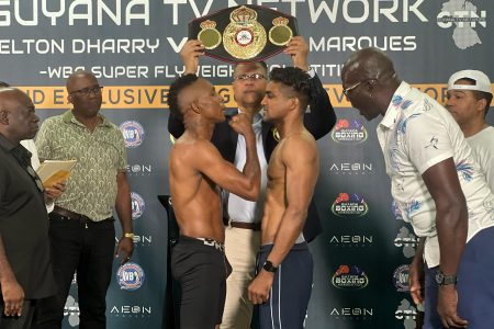 The tension ran high as Dexter Marques (left) and Elton Dharry faced off last evening ahead of their WBA Super Flyweight Gold Belt (in the background) title bout slated for tonight